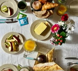 Set table with pastries, fruits, and drinks, perfect for a cozy breakfast or brunch