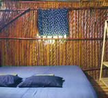 Cozy room with a comfortable sofa on the porch, perfect for relaxing in a rustic bamboo hut.