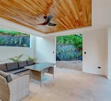 a living room with a ceiling fan and a ceiling fan