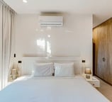 a bedroom with a bed and a large window