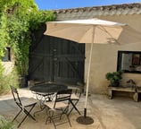 a patio table with chairs and umbrellas