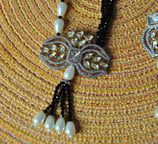 a necklace with pearls and pearls on it