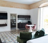 a bedroom with a bed, couch, and television