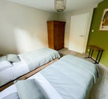 a bedroom with two beds and a table