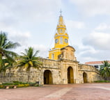 a church with a clock tower in the background