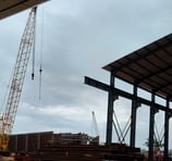 a crane is in the foreground of a construction site