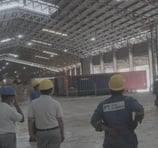 a group of people standing in a warehouse