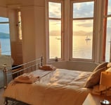 A kingsize master bed room at Gourock Seaview Holidat Let with views across the sea