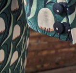Covered buttons of a green art nouveau 50's inspired cropped jacket