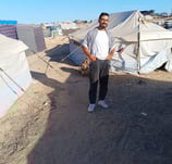 a man standing in front of a tent with tents and tents