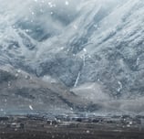 a train traveling through a snowy mountain range