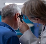 a doctor examining a patient's ear and ear