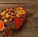 a heart shaped bowl with nuts