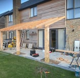 a house with a timber roof and a ladder