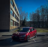 A red car parked in a parking lot