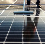 a person cleaning a solar paneled floor