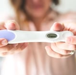 woman holding pregnancy test