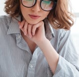 a woman sitting at a desk with a notebook and a notebook