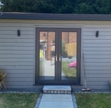 grey garden room in. the corner of a garden built by lakes building and plastering services