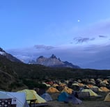 A tent pitched up in Paine Grande campsite with Cerro Cuerno Principal 