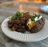 steak bites and baked potatoes