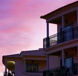 Building with balconies under the beautiful pink sunset