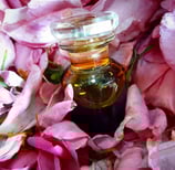 Perfume flask with rose petals
