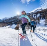 Snow covered mountain with snowshoeing hikers in the Alps