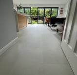 A tile effect LVT floor in an open plan kitchen