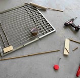 image showing cage door frame with cardboard paper and power drill tool and wood in development