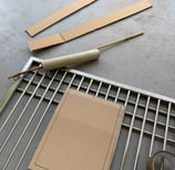 image showing cage door frame with cardboard paper in development