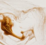 background image - gold glitters swirled on a white surface