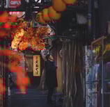 Elvin Mendoza captures the vibrant, bustling streets of Shinjuku, Tokyo where a man is smoking.