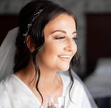 a brunette women having her bridal makeup done