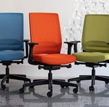 Five Sensit T129 clerical chairs in pastel purple, blue, orange, green, and side-view lilac, display