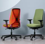 Red and green ergonomic task chairs with mesh backs and adjustable armrests