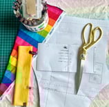 a pair of scissors with fabric and a lilrockywear sewing pattern