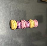 colorful half macaron fridge magnets on a grey fridge