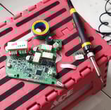 a pink box with a computer mouse and a pair of scissors