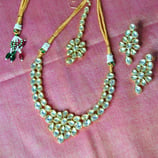 a floral necklace with pearls