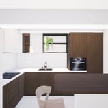 Photo du projet de transformation à Knokke vue de la cuisine en noyer et terrazzo beige