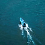 a boat with a blue and white boat in the water