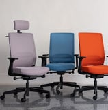 Three ergonomic office chairs in purple, blue, and orange on castors with armrests