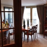 a dining room with a table and chairs