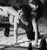 a woman doing a push up in a gym