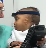 a man in a blue shirt and a baby in a blue hat