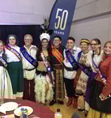 a group of people standing around a table