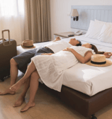a man and woman are laying on a bed