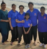 a group of people standing on a beach