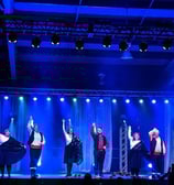 a group of people standing on a stage